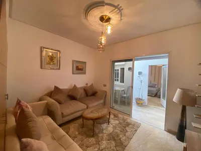 a living room with a couch and a table at Un écrin rabati in Rabat