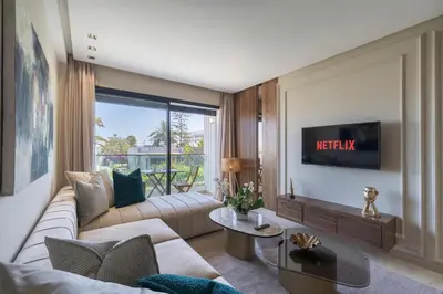 a living room with a couch and a tv at Beautiful 1 Bedroom Appartment in Anfa in Casablanca
