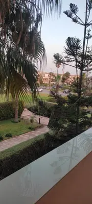 a view of a park from a window with trees at Les perles de Tamaris in Dar Mohammed Ould Haj Jilali