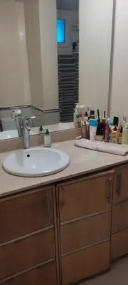 a bathroom counter with a sink and a mirror at Les perles de Tamaris in Dar Mohammed Ould Haj Jilali