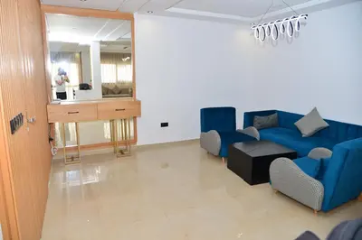 a living room with a blue couch and chairs at Bel appartement au cœur de rabat in Rabat