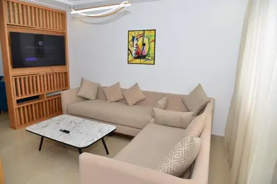 a living room with a couch and a table at Bel appartement au cœur de rabat in Rabat