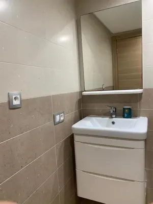 a bathroom with a sink and a mirror at appartement de antoine in Maarif