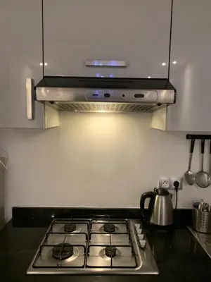 a stove top oven in a kitchen with a light at appartement de antoine in Maarif