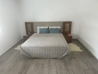 a bedroom with a large bed and two night stands at Villa luxe avec piscine in Oulad Hamida