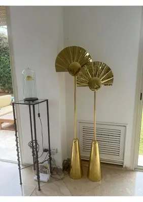 two gold umbrellas on the floor in a room at Villa luxe avec piscine in Oulad Hamida