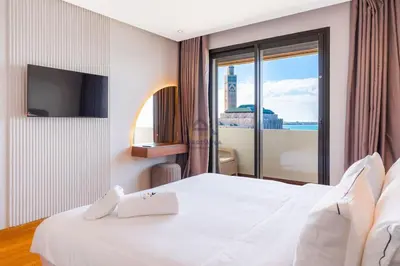 a hotel room with a bed and a large window at Royal Senior Suite 3Bd & 3Ba -By Appart Ayla in Casablanca-Port