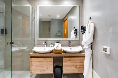 a bathroom with two sinks and a large mirror at Royal Senior Suite 3Bd & 3Ba -By Appart Ayla in Casablanca-Port