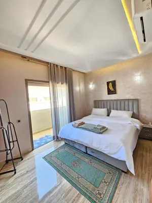 a bedroom with a bed and a large window at MIA Appartement N2 - Élégance, Confort et Sérénité in Casablanca