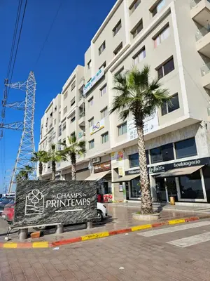 a sign in front of a building with a palm tree at MIA Appartement N2 - Élégance, Confort et Sérénité in Casablanca