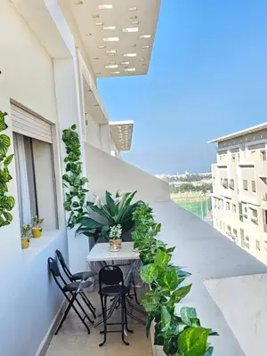 a balcony with a table and chairs and plants at MIA Appartement N2 - Élégance, Confort et Sérénité in Casablanca