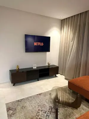 a living room with a television on a wall at Studio luxueux bien meublé in Casablanca