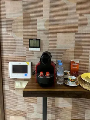 a table with a microwave and a bowl with pumpkins on it at Studio luxueux bien meublé in Casablanca
