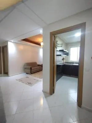 a large room with a kitchen and a living room at Appartement très propre lumineux en moyen standing a résidence klk darbouza in Casablanca
