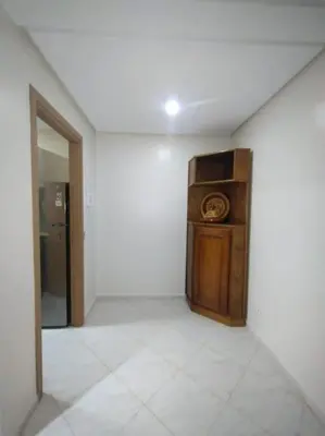 a room with a white wall and a refrigerator in it at Appartement très propre lumineux en moyen standing a résidence klk darbouza in Casablanca