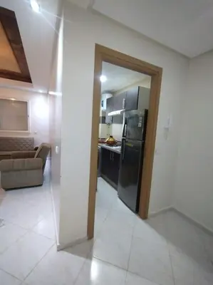 a kitchen with a black refrigerator in a room at Appartement très propre lumineux en moyen standing a résidence klk darbouza in Casablanca