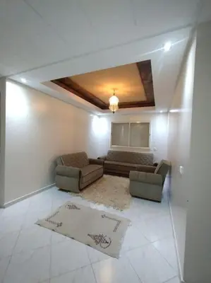 a living room with two chairs and a couch at Appartement très propre lumineux en moyen standing a résidence klk darbouza in Casablanca