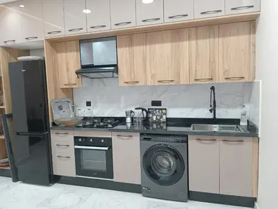 a kitchen with a stove and a washer and dryer at L'ocean in Casablanca