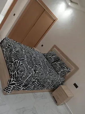 a bed with black and white sheets and pillows at L'ocean in Casablanca