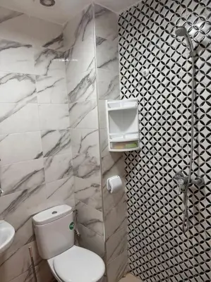 a bathroom with a toilet and a sink at Bel Appartement vue piscine in Mansouria