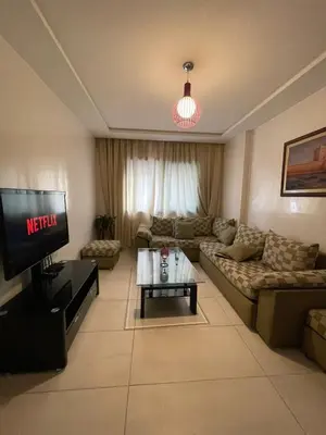 a living room with a couch and a tv at residence rania in Maarif