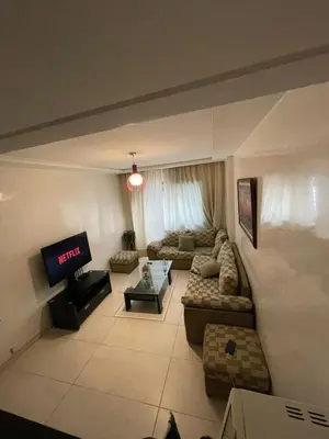 a living room with a couch and a tv at residence rania in Maarif