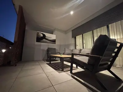 a living room with a couch and a table at Vue imprenable sur Casa Finance City in Casablanca