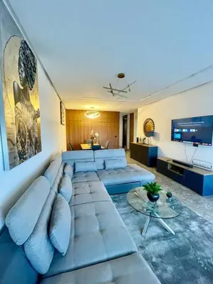 a living room with a couch and a tv at Vue imprenable sur Casa Finance City in Casablanca