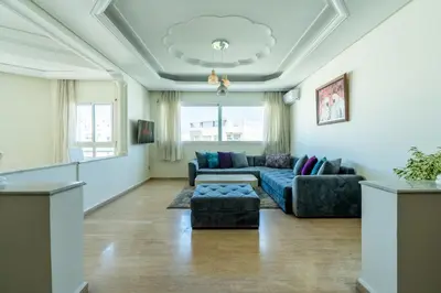 a living room with a couch and a table at Appartement à Maarif, Proche du Twin et McDonald's in Casablanca