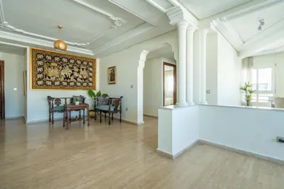 an empty living room with a table and chairs at Appartement à Maarif, Proche du Twin et McDonald's in Casablanca