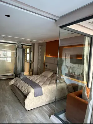 a bedroom with a large bed and a glass wall at Estay in Casablanca