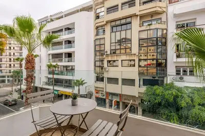 a balcony with a table and chairs and a building at Casa Gauthier - TT Holidays in Casablanca