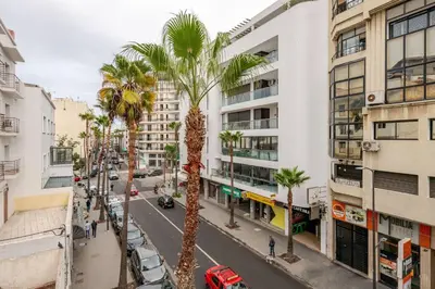 a city street with palm trees and buildings at Casa Gauthier - TT Holidays in Casablanca
