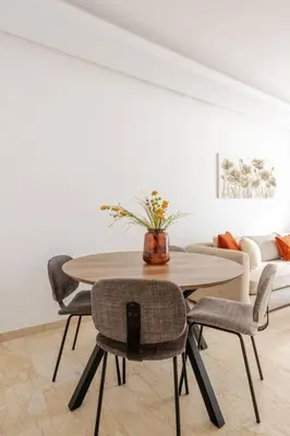 a table and chairs in a living room with a couch at Casa Gauthier - TT Holidays in Casablanca