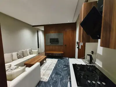 a living room with a white couch and a tv at Studio élégant in Casablanca
