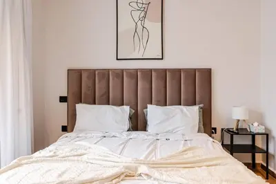 a bedroom with a large bed with a brown headboard at Emerald 32 Bourgogne Studio in Casablanca