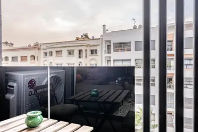 a balcony with a table and a view of a building at Emerald 32 Bourgogne Studio in Casablanca