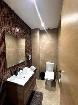 a bathroom with a sink and a toilet and a mirror at Skyline Albert Luxury 2 a proximité de la gare Casa voyageurs Casablanca in Casablanca