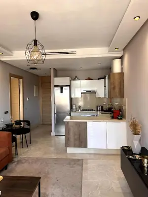 a kitchen and living room with a couch and a table at Skyline Albert Luxury 2 a proximité de la gare Casa voyageurs Casablanca in Casablanca