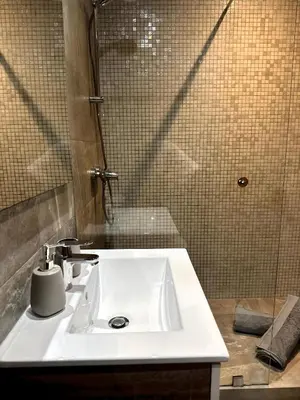 a bathroom with a white sink and a shower at Skyline Albert Luxury 2 a proximité de la gare Casa voyageurs Casablanca in Casablanca