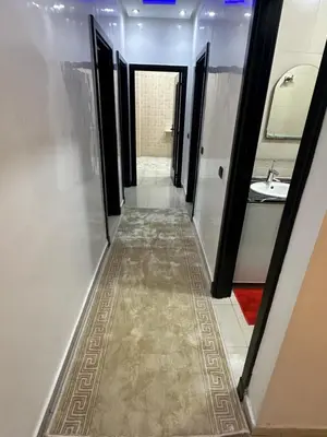 a hallway of a bathroom with a sink and a mirror at Appartement corniche d'or, Mohammedia in Mohammedia