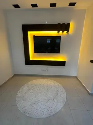 a living room with a television on a wall at Appartement corniche d'or, Mohammedia in Mohammedia