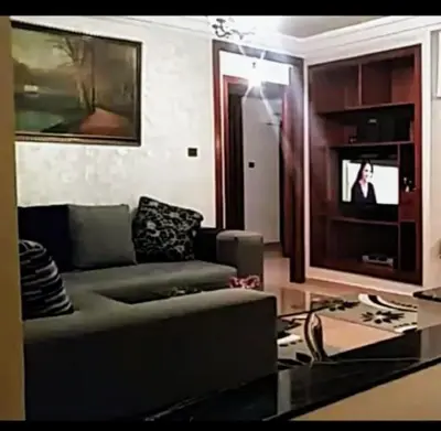 a living room with a couch and a tv at Spacious apartment in Rabat Agdal 1937,5 ft2 - 180m2 in Rabat