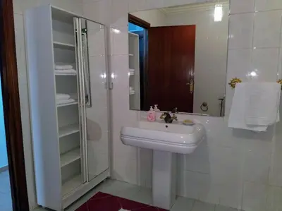 a bathroom with a sink and a shower at Spacious apartment in Rabat Agdal 1937,5 ft2 - 180m2 in Rabat