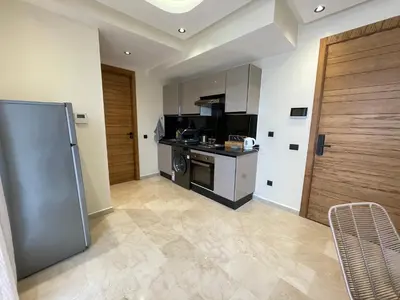 a kitchen with a refrigerator and a stove at Golden Spot Casablanca in Casablanca