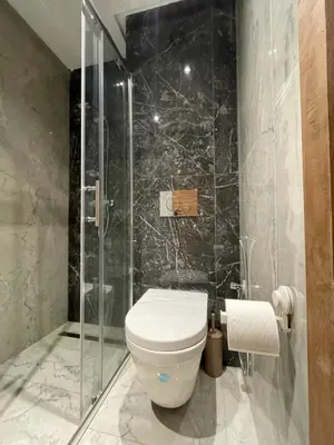 a bathroom with a toilet and a glass shower at Golden Spot Casablanca in Casablanca