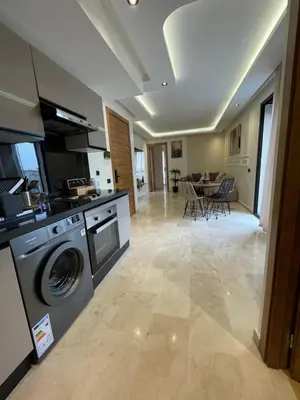 a kitchen and living room with a washing machine at Golden Spot Casablanca in Casablanca