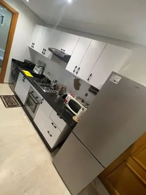 a kitchen with white cabinets and a stainless steel refrigerator at Perfect Studio in Casablanca City Center in Casablanca