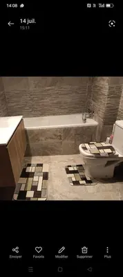 a bathroom with a toilet and a sink and a tub at Appartement spacieux 3 chambres avec parking privé in Nouaceur