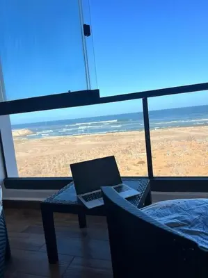 a laptop computer sitting on a table in front of a window at Appartement - EL Mansouria - Mohammadia - Bouznika in Mansouria